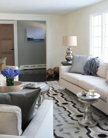 a living room with furniture and flowers