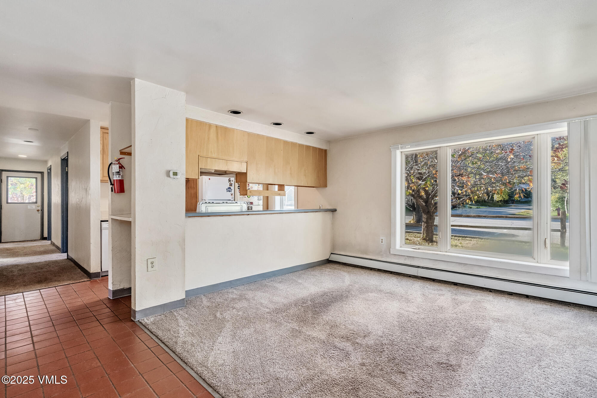 249 Eagle Road Eagle-Vail, CO 81620 - Photo 8 of 22 a view of a kitchen with refrigerator cabinets and wooden floor