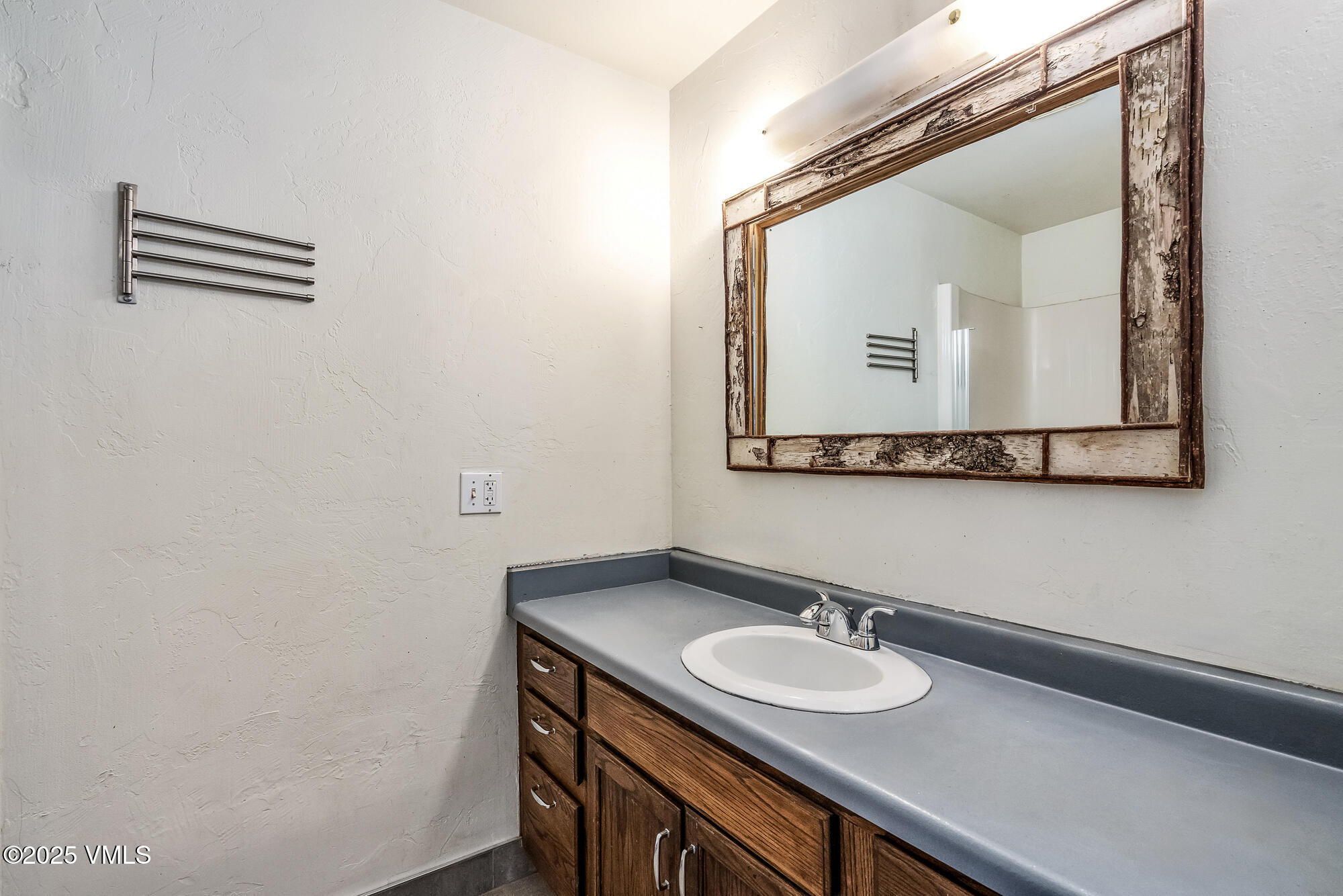 249 Eagle Road Eagle-Vail, CO 81620 - Photo 10 of 22 a bathroom with a sink and a mirror