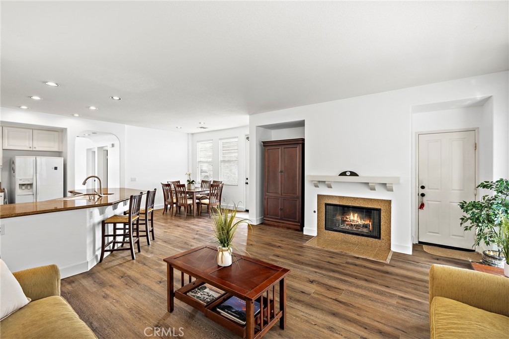 16 Skywood Street Ladera Ranch, CA 92694 - Photo 12 of 36 a living room with furniture a table and a fireplace