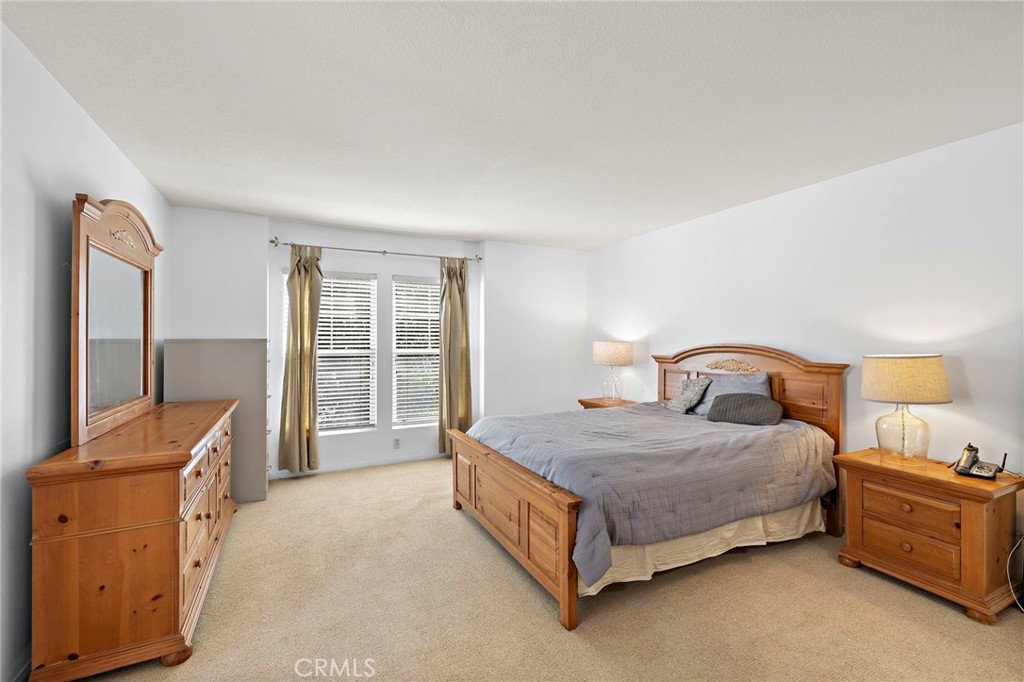 16 Skywood Street Ladera Ranch, CA 92694 - Photo 13 of 36 a bedroom with a bed and a dresser next to a window