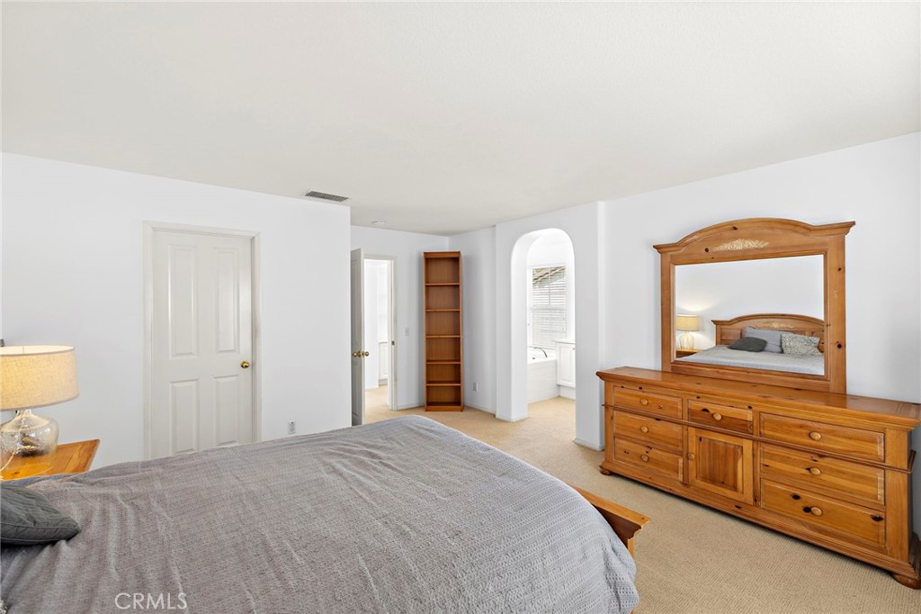16 Skywood Street Ladera Ranch, CA 92694 - Photo 14 of 36 a bedroom with a bed and a dresser in it