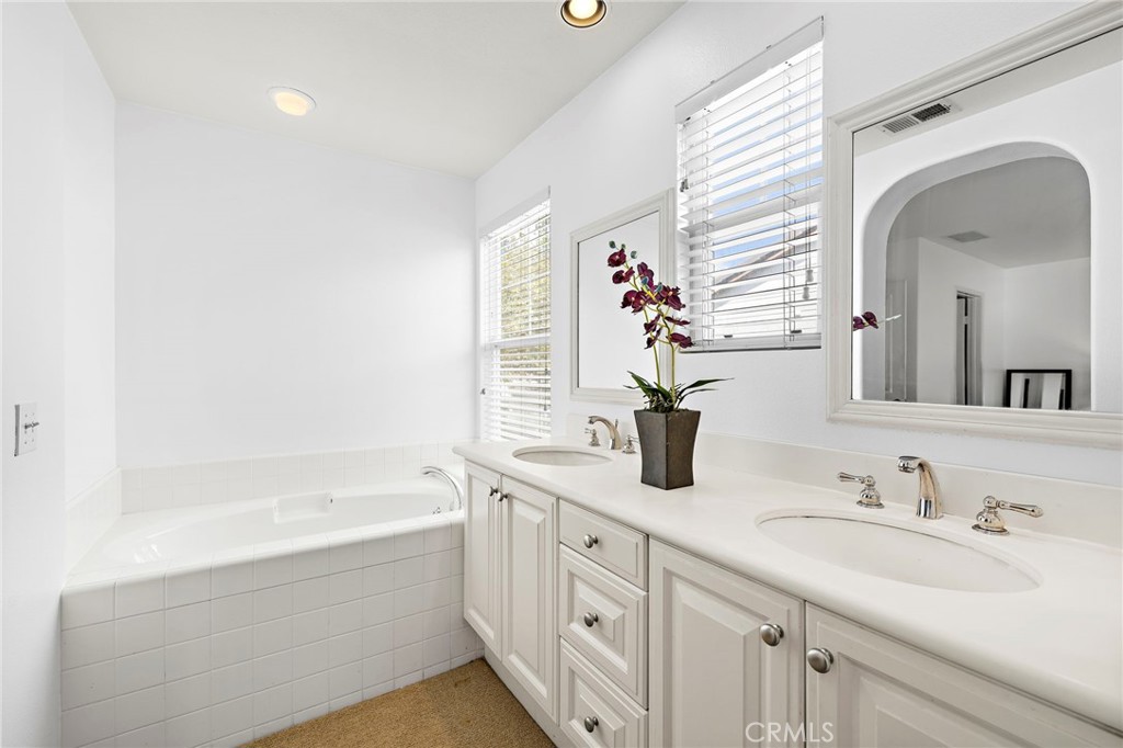 16 Skywood Street Ladera Ranch, CA 92694 - Photo 15 of 36 a bathroom with a bathtub a sink and a window