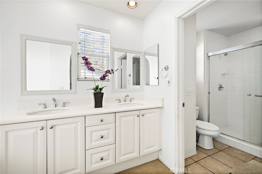 16 Skywood Street Ladera Ranch, CA 92694 - Photo 16 of 36 a bathroom with double vanity sink a mirror and a shower