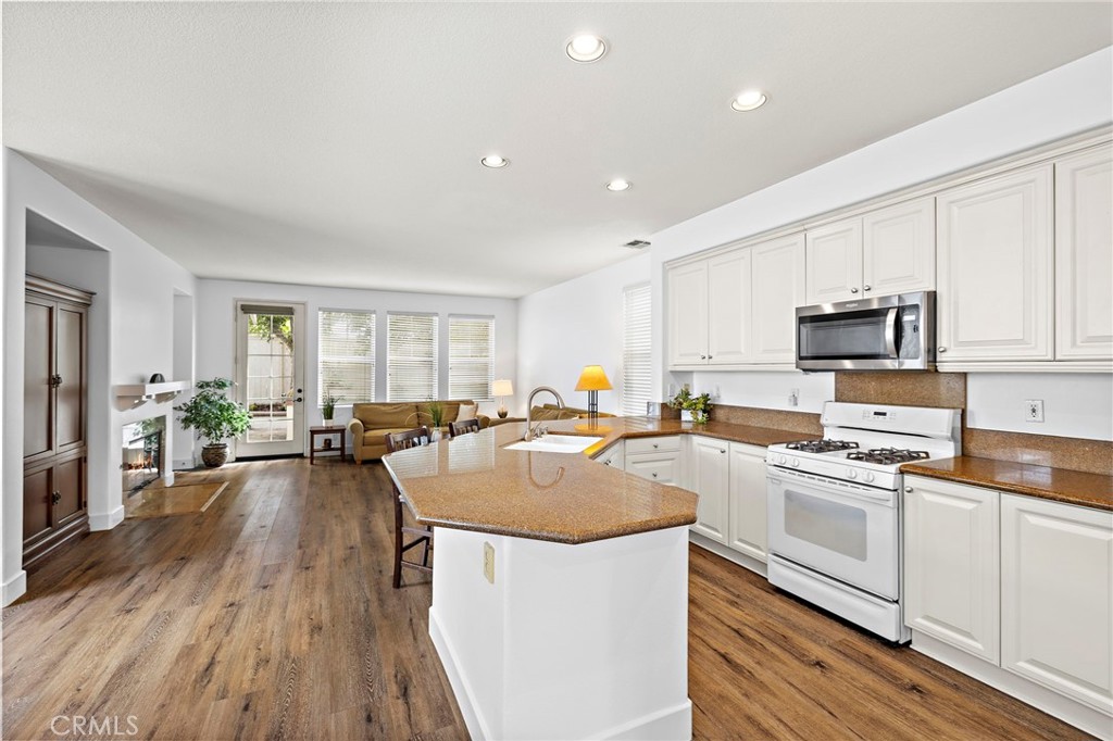 16 Skywood Street Ladera Ranch, CA 92694 - Photo 4 of 36 a kitchen with sink a counter top space appliances and cabinets