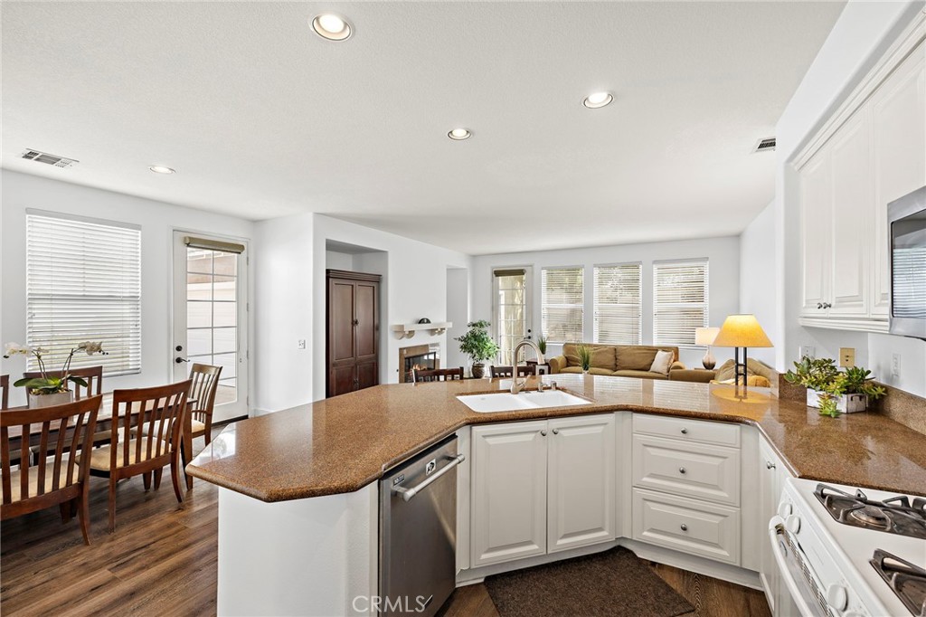 16 Skywood Street Ladera Ranch, CA 92694 - Photo 8 of 36 a large kitchen with kitchen island a sink table and chairs