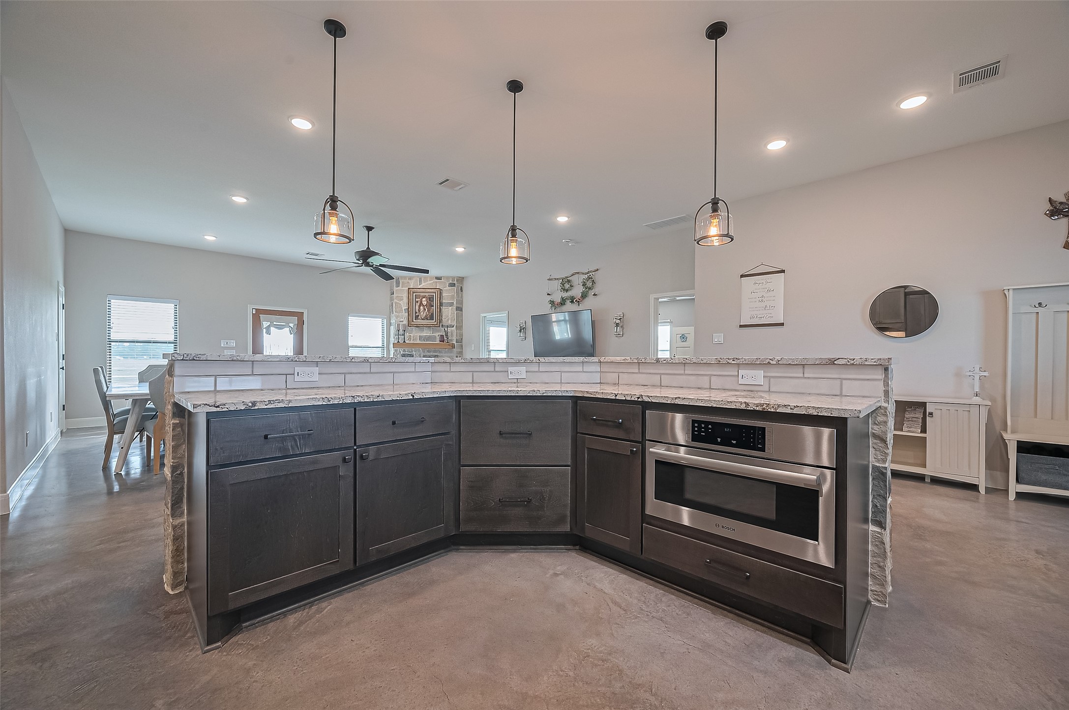 16702 Dipple Road Guy, TX 77444 - Photo 13 of 50 a kitchen with kitchen island a stove a sink a center island a dining table and chairs