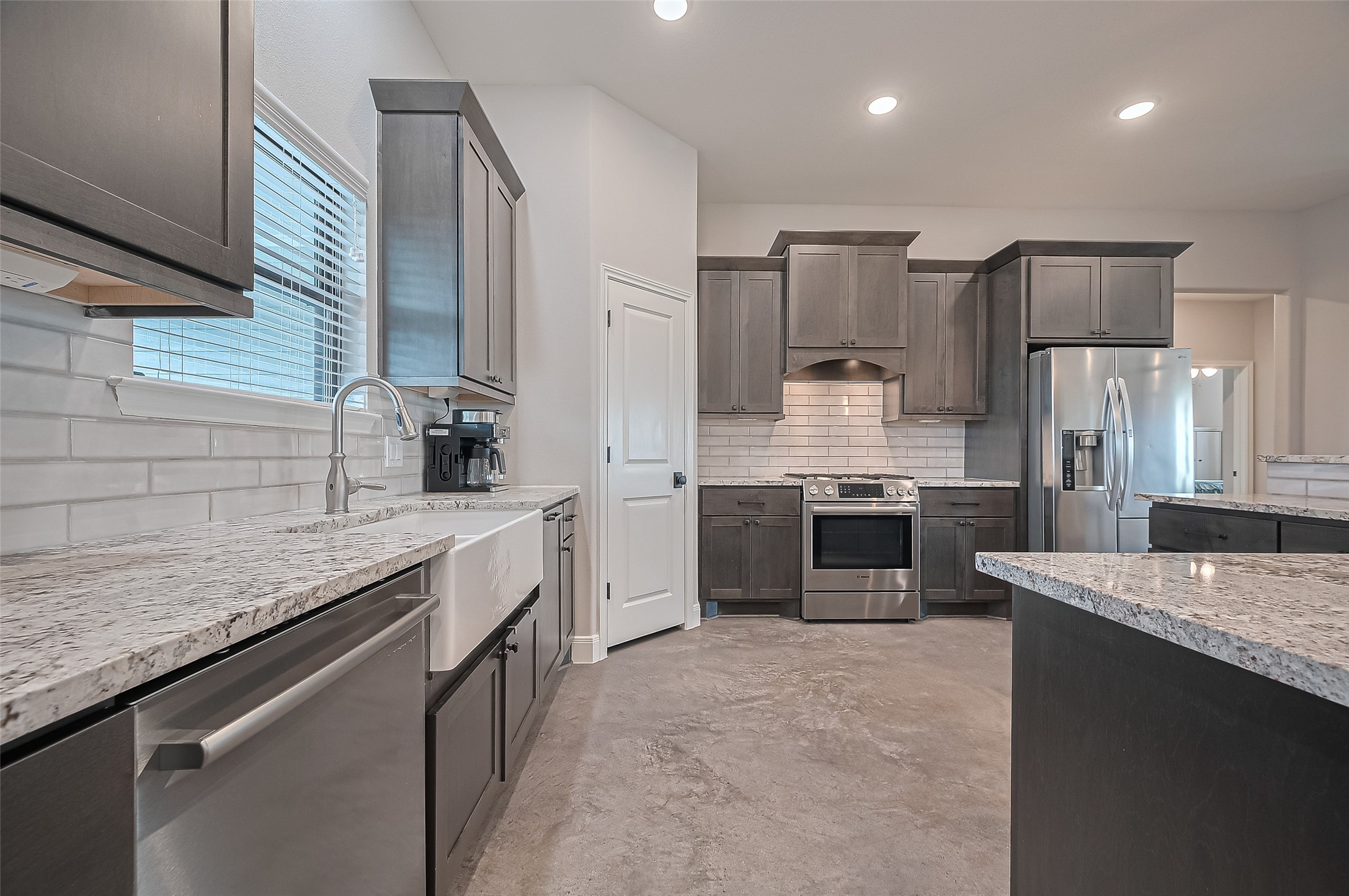 16702 Dipple Road Guy, TX 77444 - Photo 14 of 50 a kitchen with stainless steel appliances granite countertop a sink stove and refrigerator
