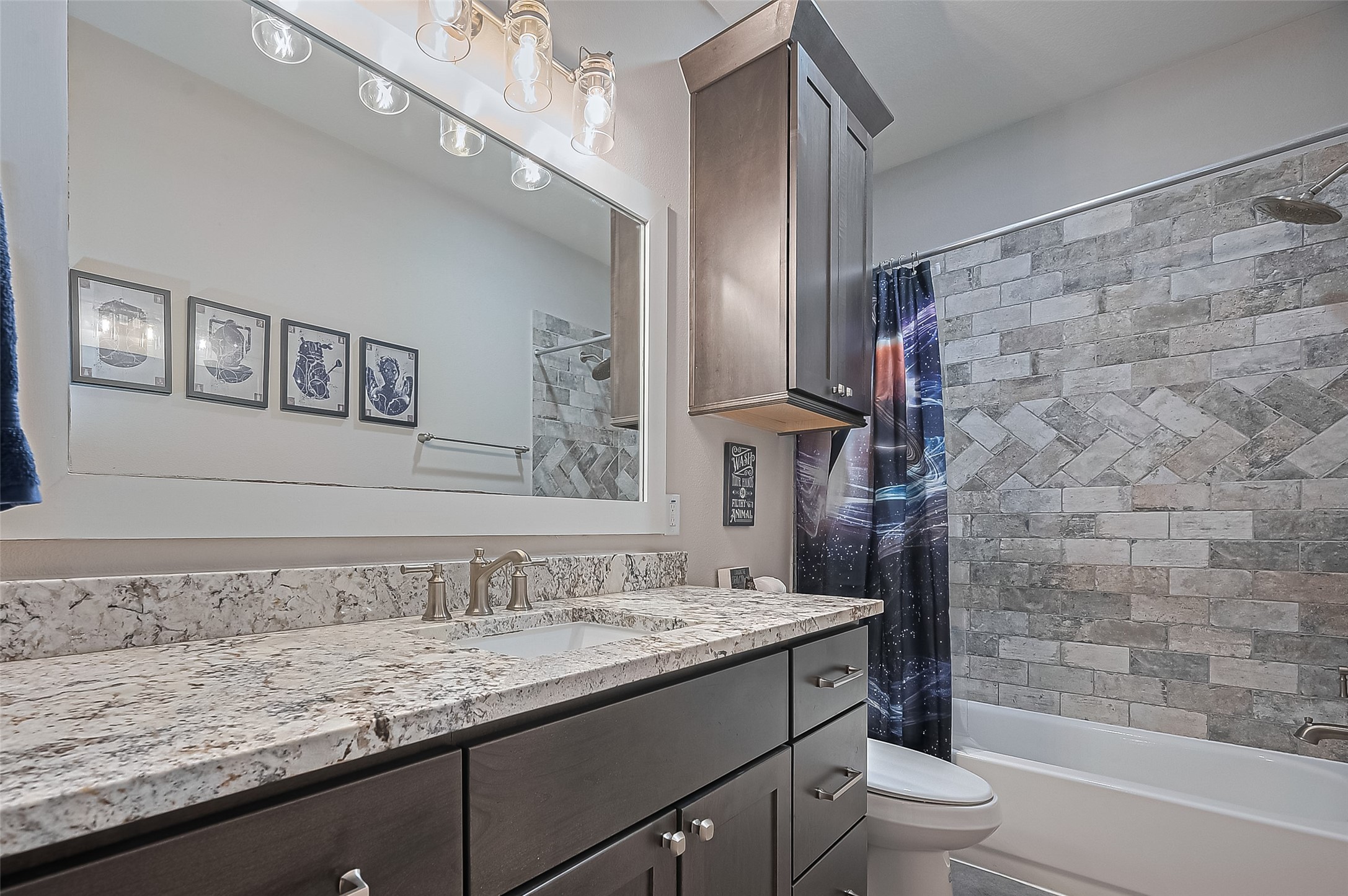 16702 Dipple Road Guy, TX 77444 - Photo 21 of 50 a bathroom with a granite countertop sink a toilet and shower