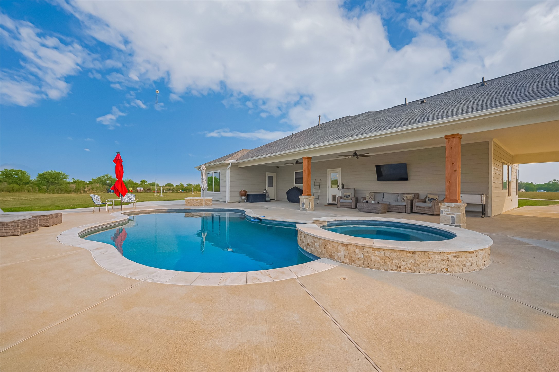 16702 Dipple Road Guy, TX 77444 - Photo 37 of 50 a swimming pool with outdoor seating and yard