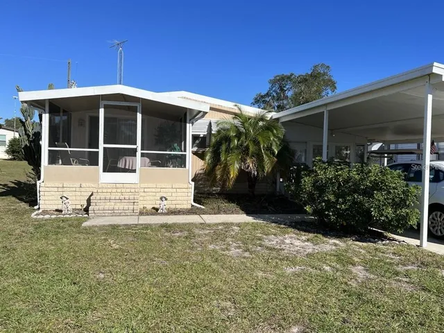 a view of a house with a yard and plants