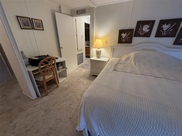 a bedroom with a bed and furniture