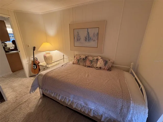 a bedroom with a bed and a mirror