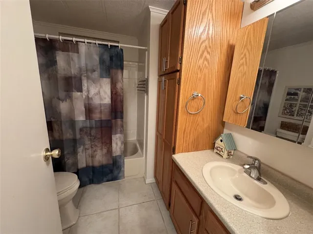 a bathroom with a sink and mirror with toilet