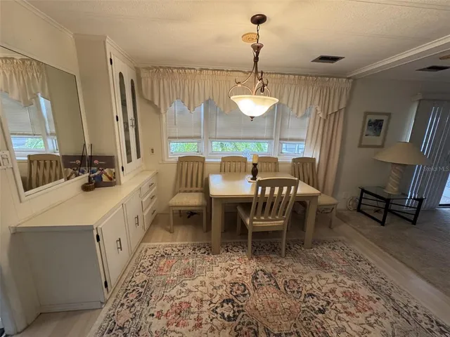 a dining room with furniture and a chandelier