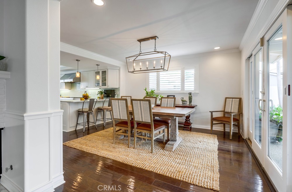2879 Clubhouse Road Costa Mesa, CA 92626 - Photo 13 of 64 a view of a dining room with furniture window and wooden floor