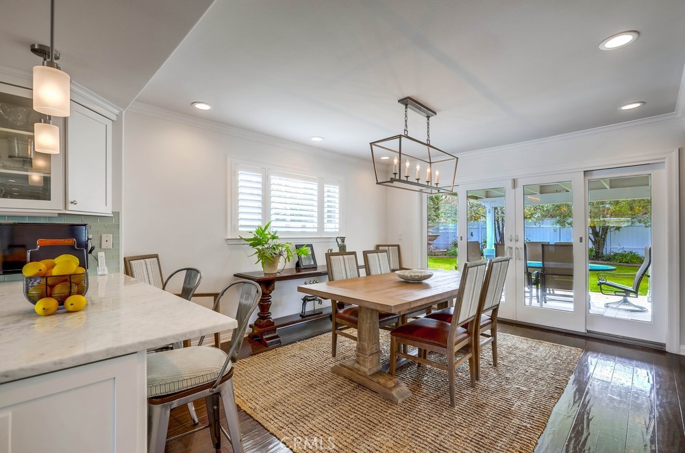 2879 Clubhouse Road Costa Mesa, CA 92626 - Photo 14 of 64 a view of a dining room with furniture window and wooden floor