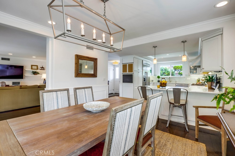 2879 Clubhouse Road Costa Mesa, CA 92626 - Photo 17 of 64 a view of a dining room with furniture and a kitchen