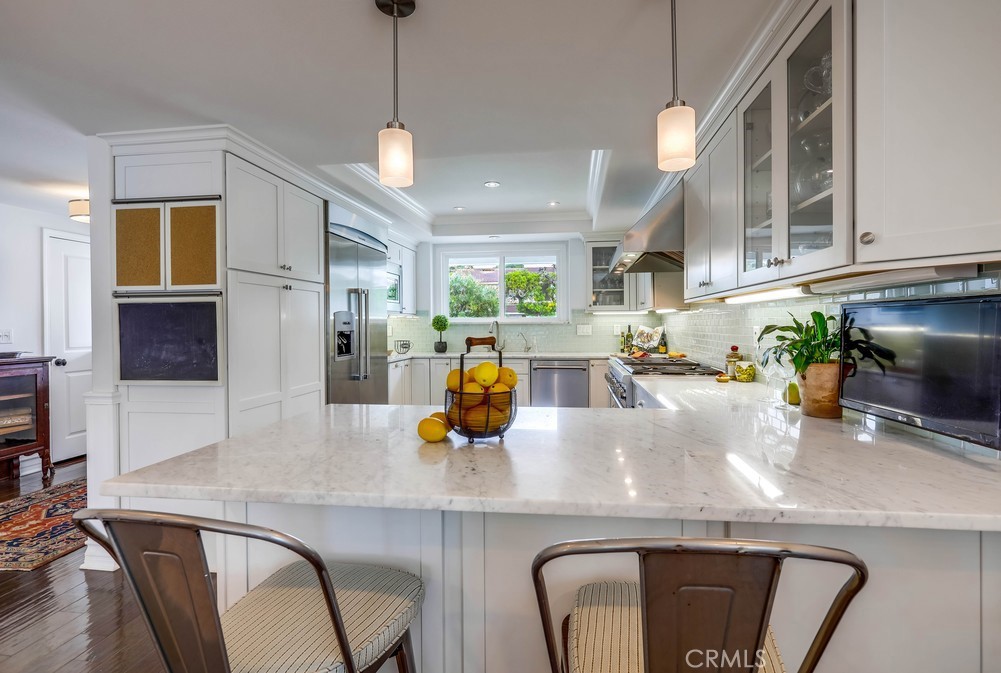 2879 Clubhouse Road Costa Mesa, CA 92626 - Photo 19 of 64 a kitchen with a table chairs refrigerator and microwave
