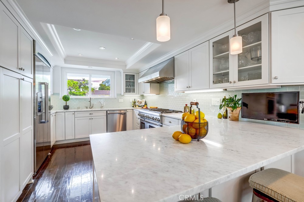 2879 Clubhouse Road Costa Mesa, CA 92626 - Photo 22 of 64 a kitchen with stainless steel appliances granite countertop a sink a stove and refrigerator