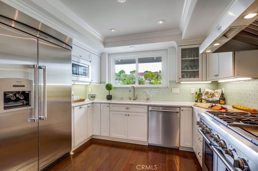 2879 Clubhouse Road Costa Mesa, CA 92626 - Photo 24 of 64 a kitchen with a sink stainless steel appliances and cabinets