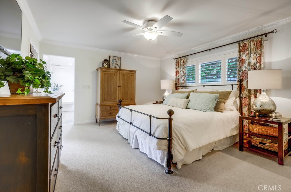 2879 Clubhouse Road Costa Mesa, CA 92626 - Photo 29 of 64 a bedroom with a bed and a chandelier