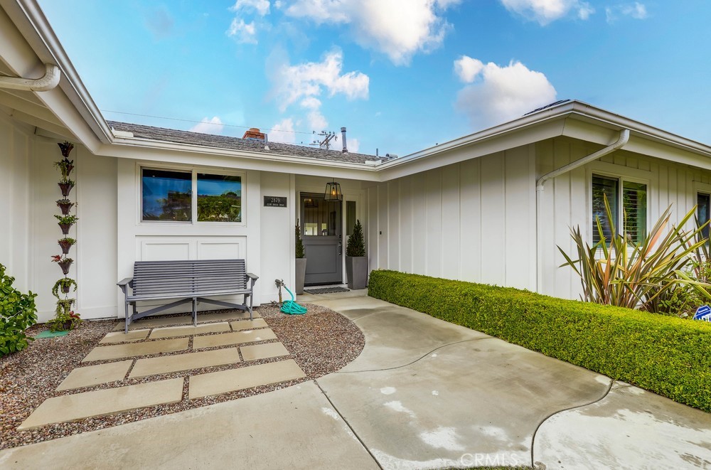 2879 Clubhouse Road Costa Mesa, CA 92626 - Photo 3 of 64 a front view of a house with a yard