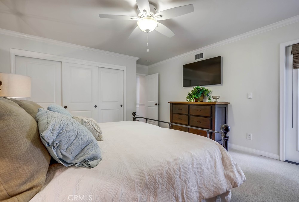 2879 Clubhouse Road Costa Mesa, CA 92626 - Photo 31 of 64 a bedroom with a bed and a flat screen tv