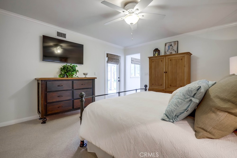 2879 Clubhouse Road Costa Mesa, CA 92626 - Photo 32 of 64 a bedroom with a bed and a flat screen tv