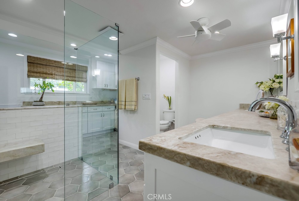 2879 Clubhouse Road Costa Mesa, CA 92626 - Photo 34 of 64 a bathroom with a granite countertop sink a mirror and shower