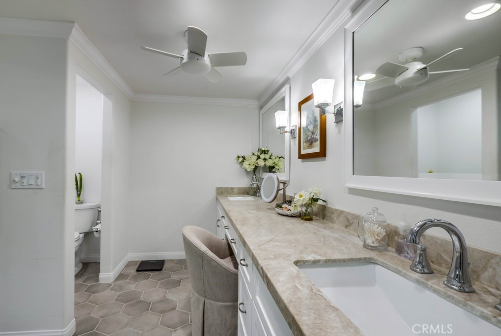 2879 Clubhouse Road Costa Mesa, CA 92626 - Photo 35 of 64 a bathroom with a granite countertop sink a toilet and mirror