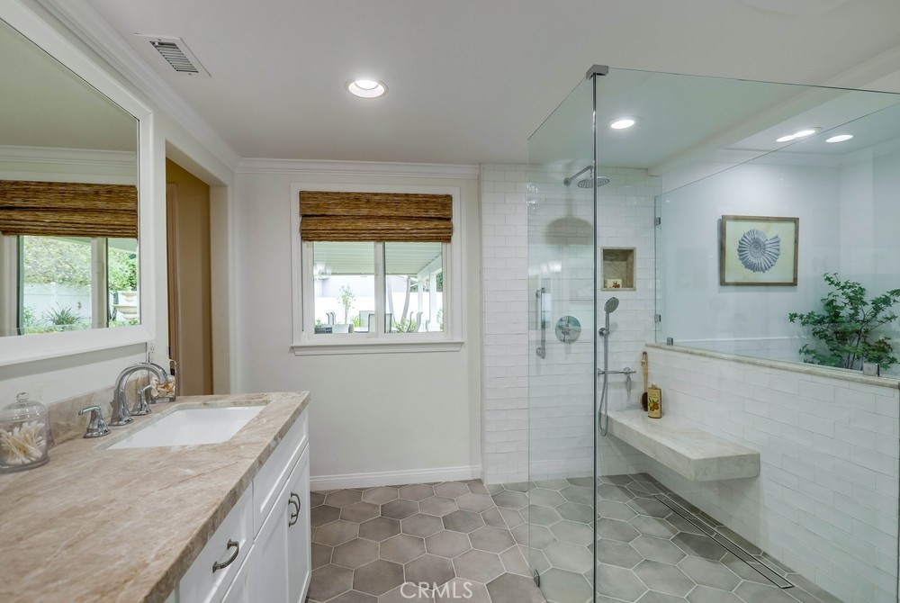 2879 Clubhouse Road Costa Mesa, CA 92626 - Photo 36 of 64 a bathroom with a granite countertop sink a mirror and a bathtub