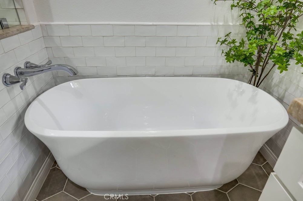2879 Clubhouse Road Costa Mesa, CA 92626 - Photo 39 of 64 a white bath tub sitting in a bathroom