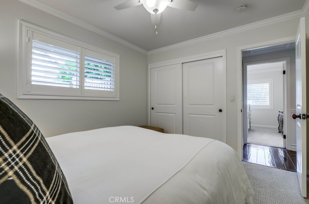 2879 Clubhouse Road Costa Mesa, CA 92626 - Photo 50 of 64 a bedroom with a bed and a chandelier