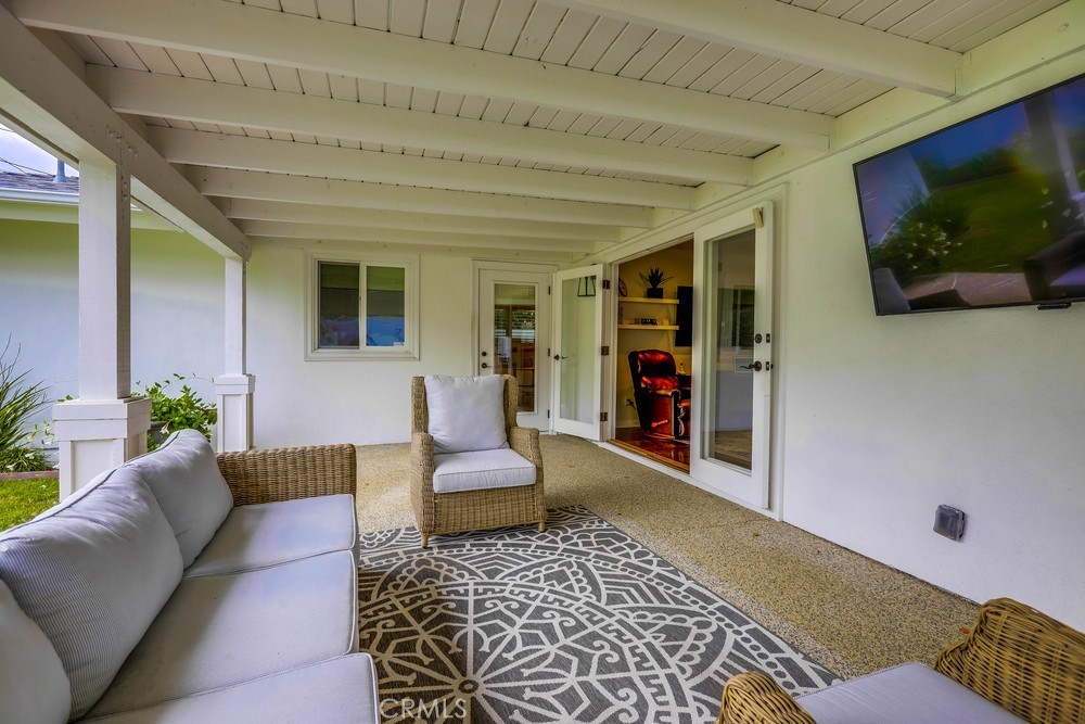 2879 Clubhouse Road Costa Mesa, CA 92626 - Photo 57 of 64 a living room with furniture and a flat screen tv