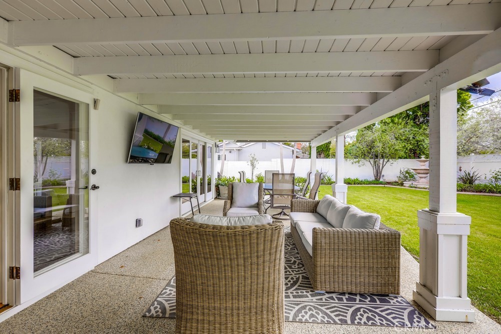 2879 Clubhouse Road Costa Mesa, CA 92626 - Photo 63 of 64 a living room with patio furniture and floor to ceiling windows