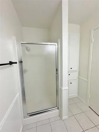 a bathroom with a glass shower door