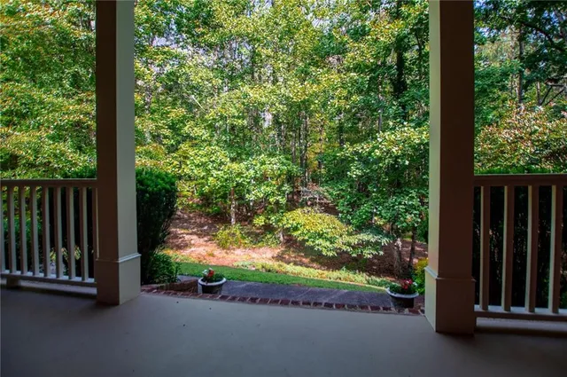 a living room with furniture a fireplace and a potted plant