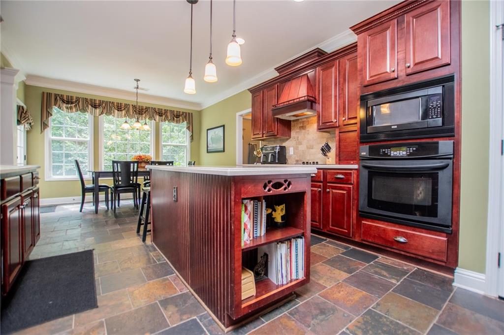5522 Tyree Road Winston, GA 30187 - Photo 39 of 45 a kitchen with stainless steel appliances granite countertop a stove a sink and a microwave