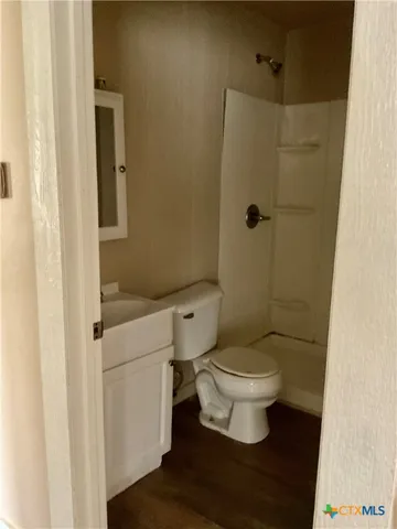 a white toilet sitting next to a bathroom sink