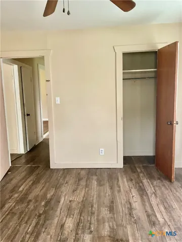 a view of an empty room with closet