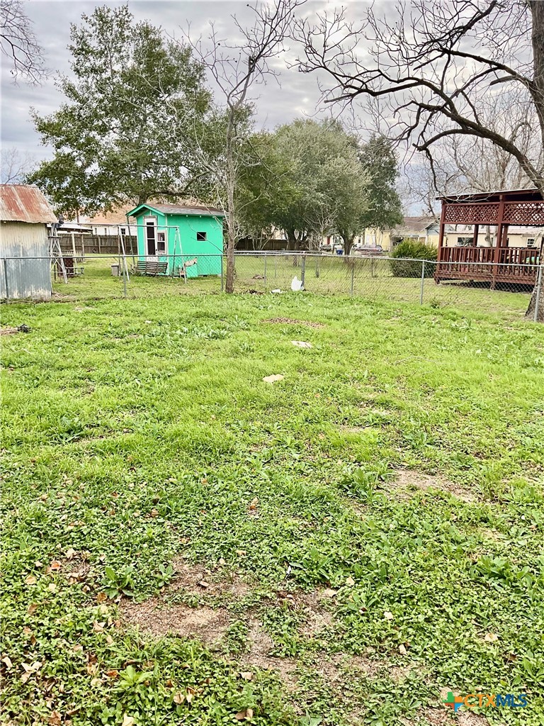 102 Clark Street Yoakum, TX 77995 - Photo 17 of 18 a backyard of a house with lots of green space and garden view