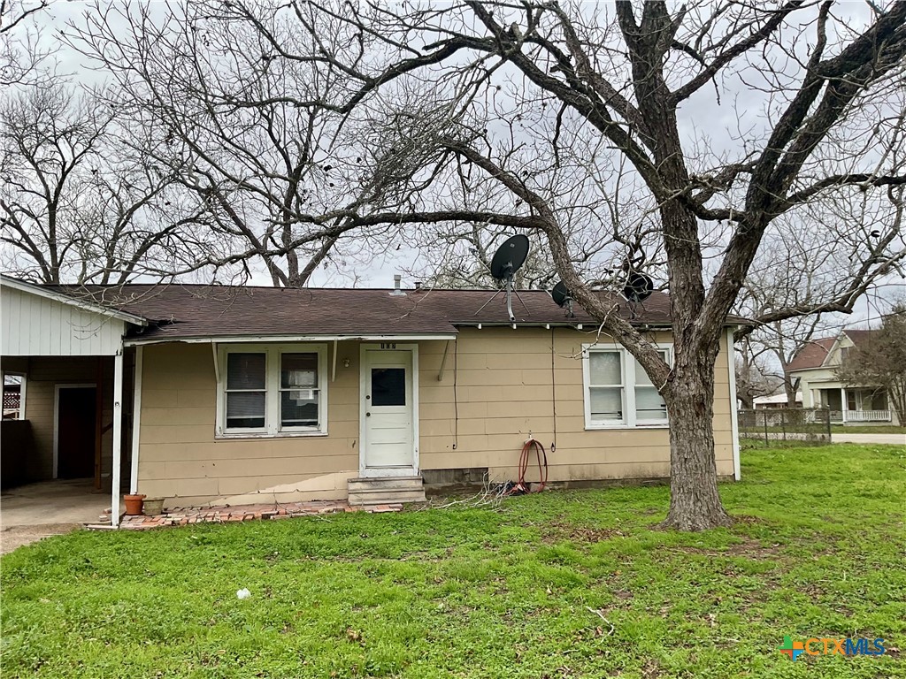 102 Clark Street Yoakum, TX 77995 - Photo 5 of 18 a house that has a tree in front of a house