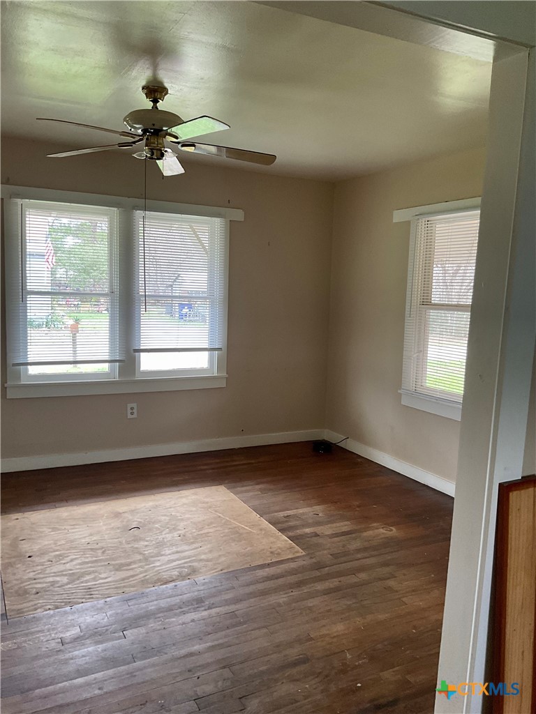 102 Clark Street Yoakum, TX 77995 - Photo 8 of 18 a view of an empty room with wooden floor and a window