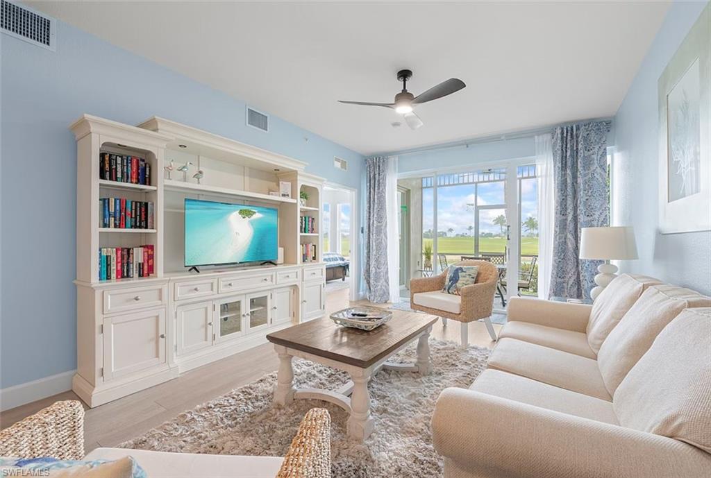 7915 Mahogany Run Lane, Unit 1114 Naples, FL 34113 - Photo 1 of 18 a living room with furniture and a flat screen tv