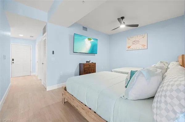 a bedroom with a bed and a painting on the wall
