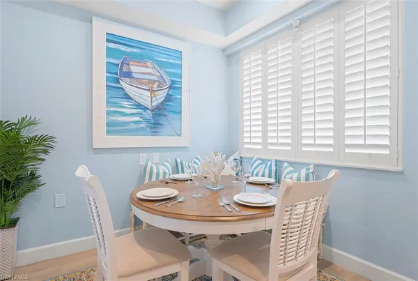 a view of a dining room with furniture and window