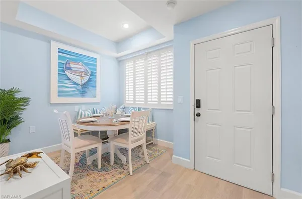 a dining room with wooden floor and a window