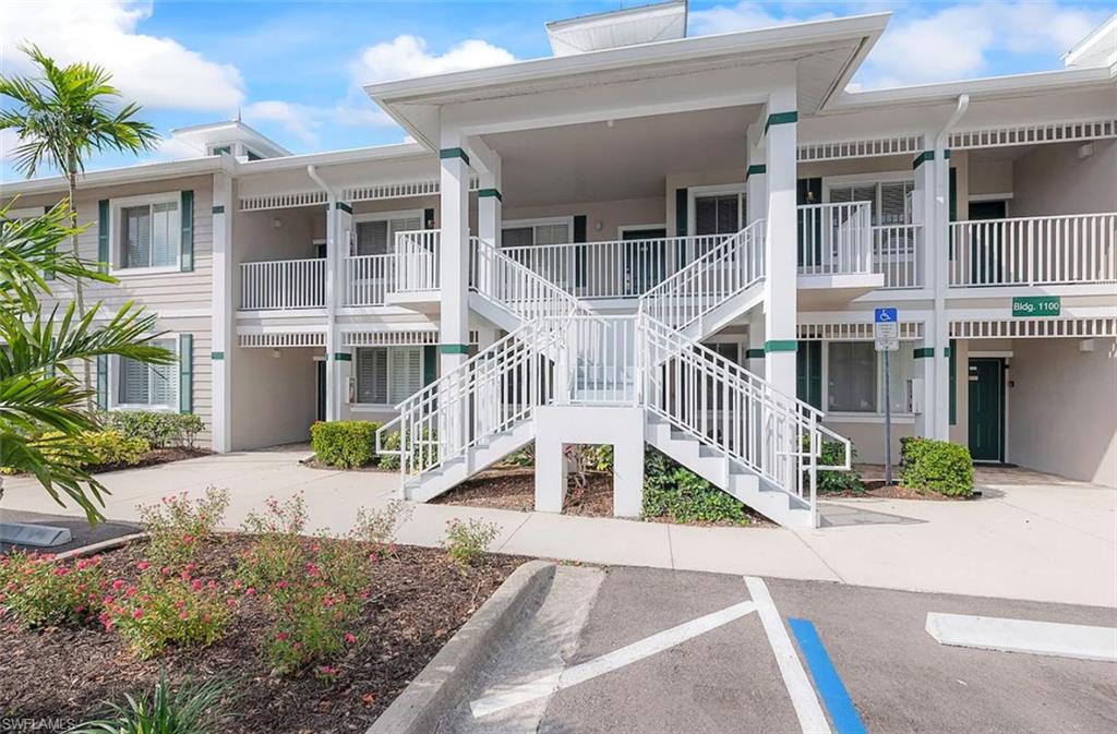 7915 Mahogany Run Lane, Unit 1114 Naples, FL 34113 - Photo 17 of 18 a front view of a house with a yard