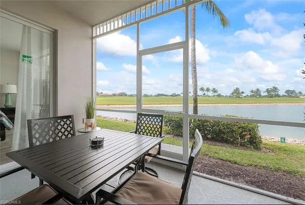 a view of a balcony with a table and chairs